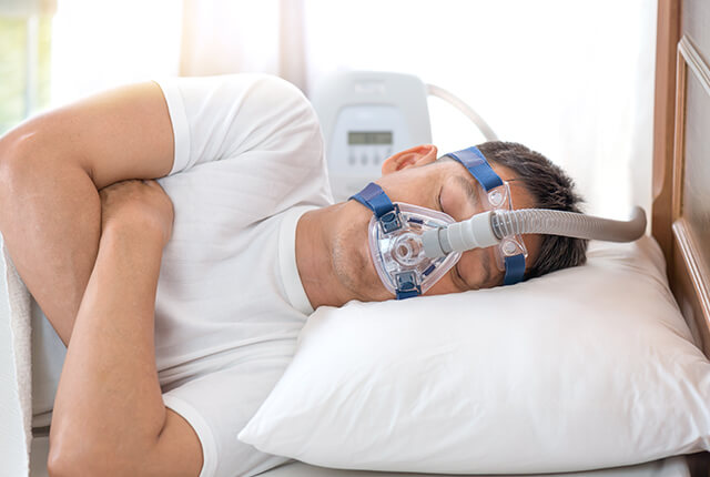 CPAP装置を装着して眠る男性